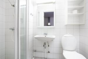 a white bathroom with a toilet and a sink at Bjorli Apartment 203 (200m til Skitrekk) in Bjorli