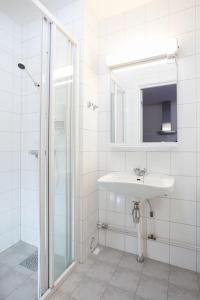 a white bathroom with a sink and a shower at Bjorli Apartment 203 (200m til Skitrekk) in Bjorli