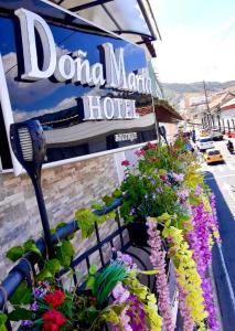 a sign for a dord moro hotel with flowers at Hotel Boutique Doña Maria in Ocaña
