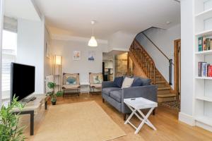 a living room with a couch and a tv at Mackerel Sky in Penzance