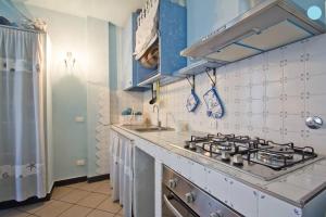 a kitchen with a stove and a sink at Case Vacanze Borgo Marina IMPERIA in Imperia