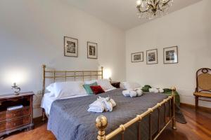 a bedroom with a bed with towels on it at Gastone Apartment by Mamo Florence in Florence
