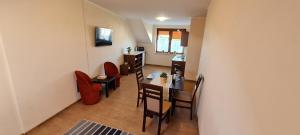 a living room with a dining room table and chairs at Pokoje i apartamenty "U Beaty" in Karwia