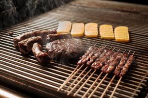 a grill with meat and other food on it at HOTEL MIRAMONTI ENOTECA in Pove del Grappa