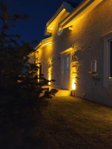 a house with a light on the side of it at night at Villa Ladybug Unique design of your dreams in Foca