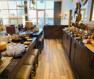 a restaurant with a long counter with food on it at Crowne Plaza Fredericton Lord Beaverbrook, an IHG Hotel in Fredericton