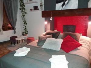 a bedroom with a large bed with a red headboard at VILLA DEL PARCO in Mesnil-la-Comtesse