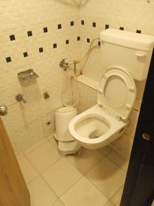 a bathroom with a toilet and a shower at Hotel Maan Palace in Ahmedabad