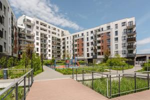 an apartment complex with a playground in front of buildings at Chill Apartments Ursynów Premium in Warsaw