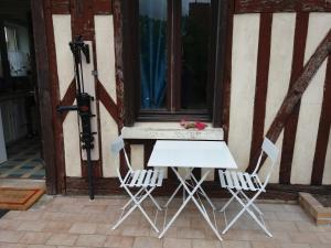 a white table and two chairs in front of a window at VILLA DEL PARCO in Mesnil-la-Comtesse