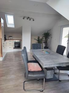 a kitchen and dining room with a large table and chairs at Urlaub schwäbische Albkante 