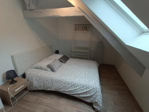 a bedroom with a bed in a attic at Chanoine Boursier in Dol-de-Bretagne