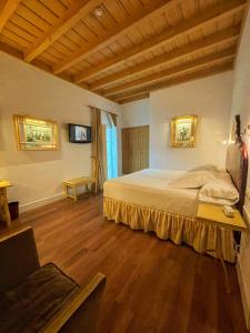 a bedroom with a large bed and wooden floors at Las Casas de la Judería de Córdoba in Córdoba