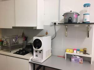 a kitchen with a microwave on a counter at Azin Ramli Studio in Seri Kembangan