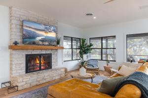 a living room with a couch and a fireplace at Amazing Modern Farmhouse Retreat w/ 2 Suites in Canyon Lake