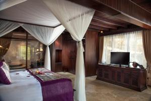 A bed or beds in a room at Pita Maha Resort & Spa