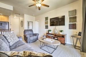 a living room with a couch and a tv at Mesquite Desert Retreat Near Golf and Casinos! in Mesquite