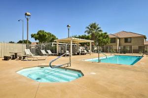 a swimming pool with a slide and a picnic table at Mesquite Desert Retreat Near Golf and Casinos! in Mesquite