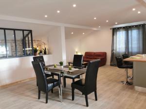 a dining room with a table and chairs and a couch at Loft 90m2 - Tout confort in Libourne