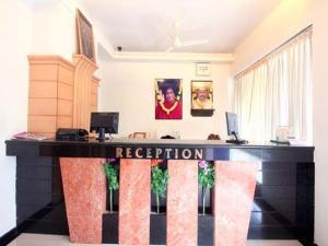 a black and red reception desk in a room at Sitara Paradise in Hyderabad