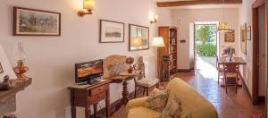 a living room with a couch and a tv at Castello Santa Cristina in Grotte di Castro