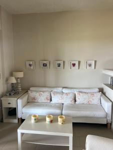 a living room with a white couch and a table at Summer House @Fourka Beach in Skala Fourkas