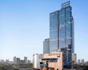 a city with tall buildings and a sky background at Ascott Kuningan Jakarta in Jakarta