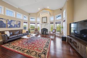 a living room with a couch and a television at HUGE Crystal Lake 7 Acre Ranch w Pool and Indoor Spa in McHenry