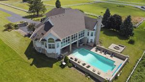 an aerial view of a large house with a swimming pool at HUGE Crystal Lake 7 Acre Ranch w Pool and Indoor Spa in McHenry