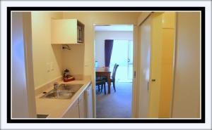 a kitchen with a sink and a dining room at Ascot On Fenton in Rotorua