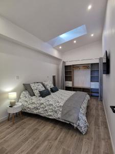a bedroom with a large bed and a television at Loft 90m2 - Tout confort in Libourne