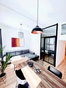 a living room with a table and a couch at Inner City Design Loft in Innsbruck
