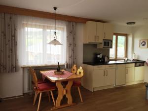 a kitchen with a wooden table and a dining room at Alpenflair Ferienwohnung 228 Söllereck in Oberstdorf