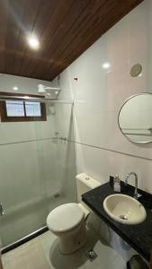 a bathroom with a toilet and a sink and a shower at Canoa Abraão in Abraão