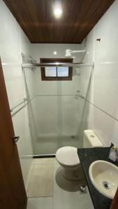 a bathroom with a shower and a toilet and a sink at Canoa Abraão in Abraão