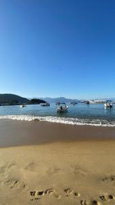 a couple of footprints in the sand on the beach at Canoa Abraão in Abraão