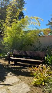 a wooden bench sitting in the middle of a garden at Canoa Abraão in Abraão
