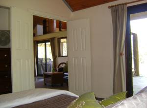 a bedroom with a bed and a sliding glass door at Scotsdale Valley Studios in Harewood