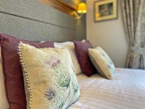 a bedroom with a bed with pillows at The Jug And Bottle in Heswall