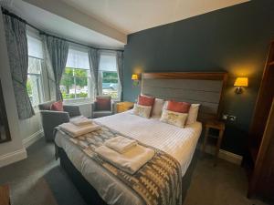 a bedroom with a bed with two towels on it at The Jug And Bottle in Heswall