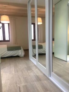 a room with two mirrors and a bedroom with a bed at NEW! Renovated house with terrace in Cambrils in Cambrils