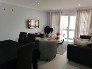 a living room with a couch and a table at Caribbeans Estates Villa T13 Tortuga in Port Edward