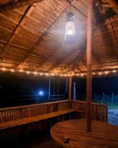 a room with a wooden ceiling with a light on it at KARIYIL KAYALORAM HOMESTAY in Shertallai