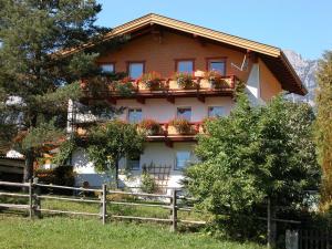 a house with potted plants on the side of it at Haus Waldfriede in Pertisau