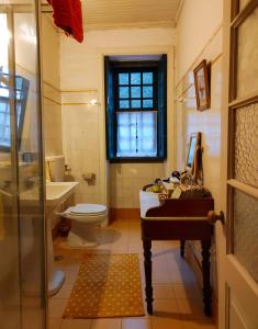 a bathroom with a toilet and a sink at Lugar da Pedra Alta - B&B - Private Historical Villa in Melo +93 photos