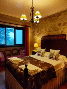 a bedroom with a large bed in a room at Lugar da Pedra Alta - B&B - Private Historical Villa in Melo