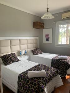 a bedroom with two beds and a window at Like at Home Ezeiza in Ezeiza