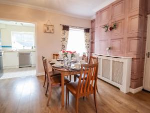 a dining room with a table and chairs at Nantclwyd in Llangollen