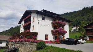 a building with flowers on the side of it at Pension Burgschroffen in Fendels