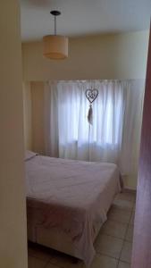 ein Schlafzimmer mit einem Bett mit einem Herz auf dem Vorhang in der Unterkunft Excelente departamento en zona céntrica. C/Cochera in Río Cuarto